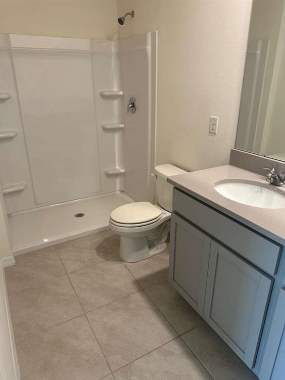 1773 Rock Elm Road Davenport, FL 33837 - Photo 5 of 23 a bathroom with a sink a toilet and shower
