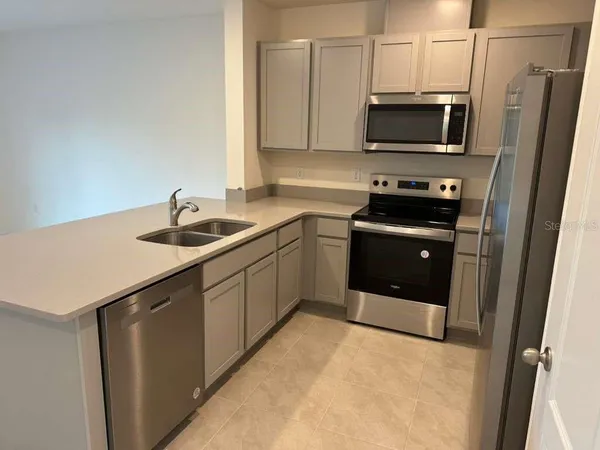 a kitchen with a sink appliances and cabinets