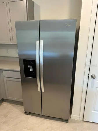 a kitchen with a refrigerator and a stove
