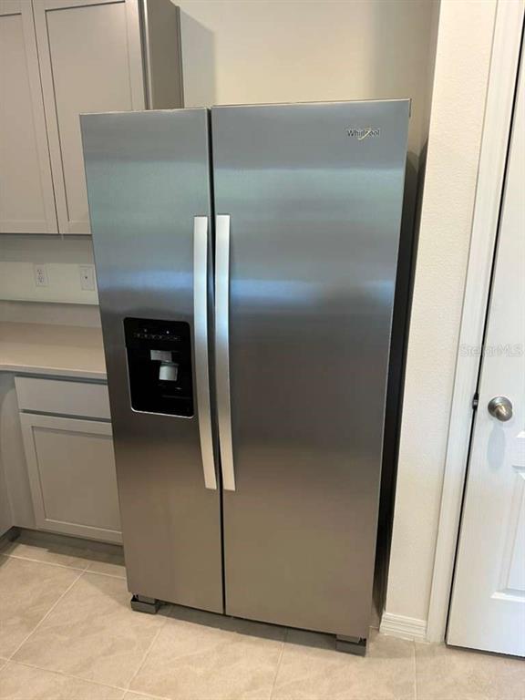 1773 Rock Elm Road Davenport, FL 33837 - Photo 9 of 23 a kitchen with a refrigerator and a stove