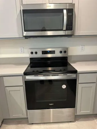 a stove top oven sitting inside of a kitchen