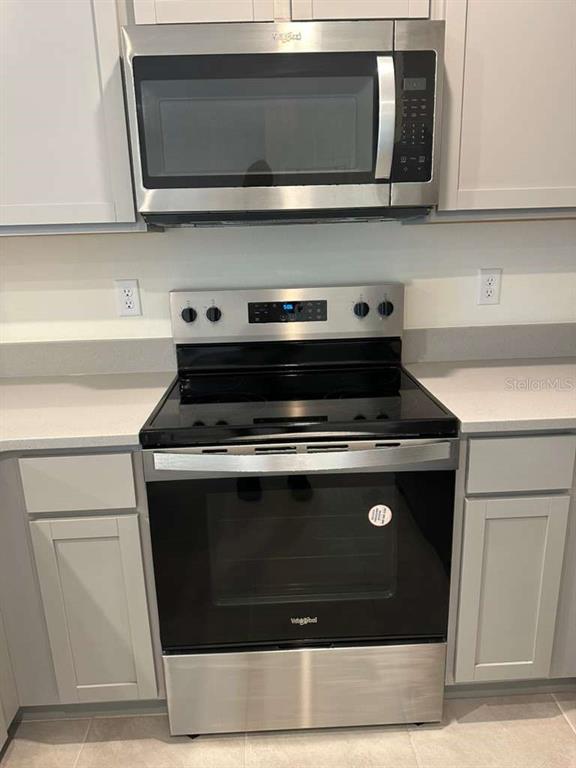 1773 Rock Elm Road Davenport, FL 33837 - Photo 10 of 23 a stove top oven sitting inside of a kitchen