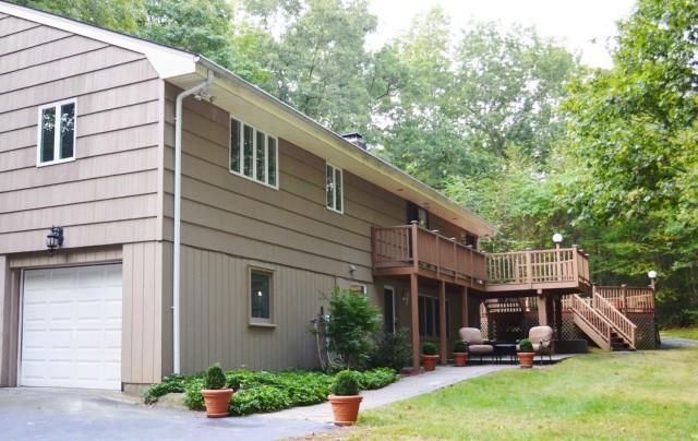411 Rock Ridge Road Fairfield, CT 06824 - Photo 1 of 1 a view of a patio with a chairs under an umbrella