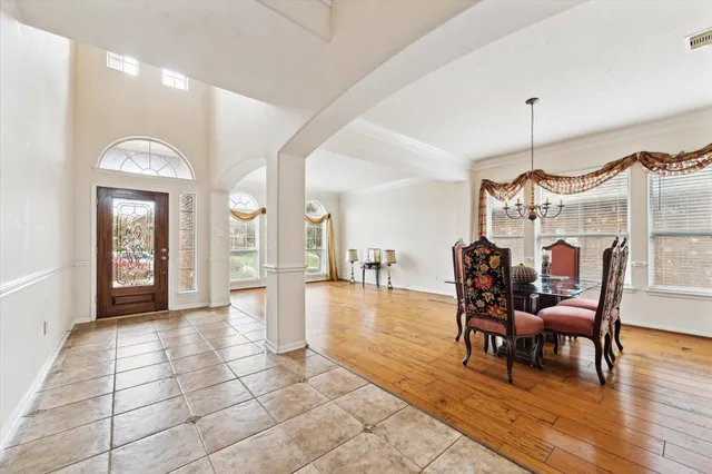 a view of a room with wooden floor furniture and a chandelier