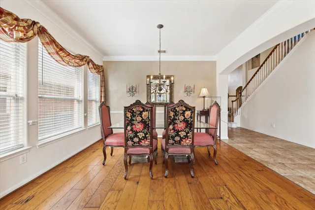a living room with furniture a chandelier and a fireplace