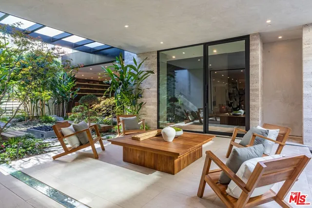 a building outdoor space with patio furniture and potted plants