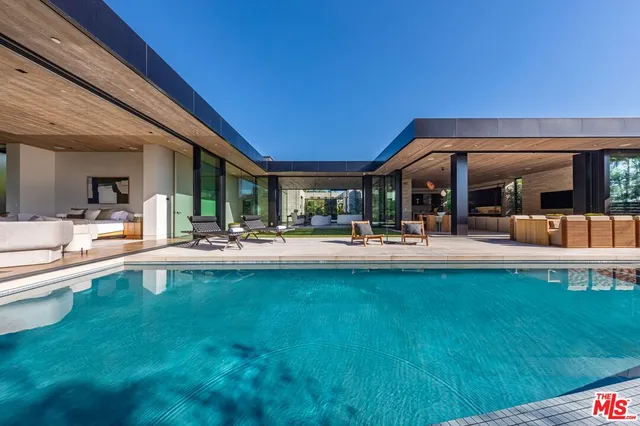 a view of swimming pool with outdoor seating and a patio