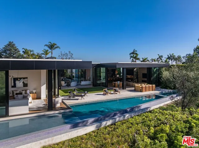a view of a house with swimming pool and sitting area