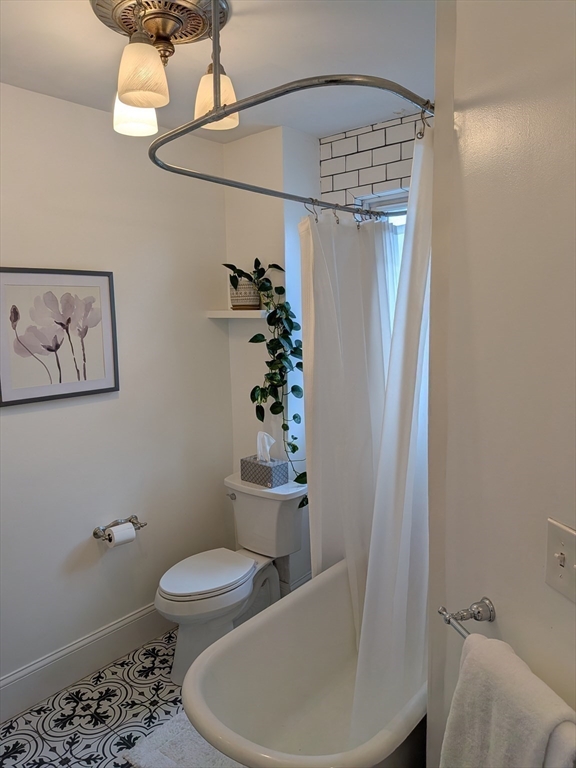 82 Gladstone Street, Unit 2 Boston, MA 02128 - Photo 14 of 23 a bathroom with a sink a toilet and a mirror