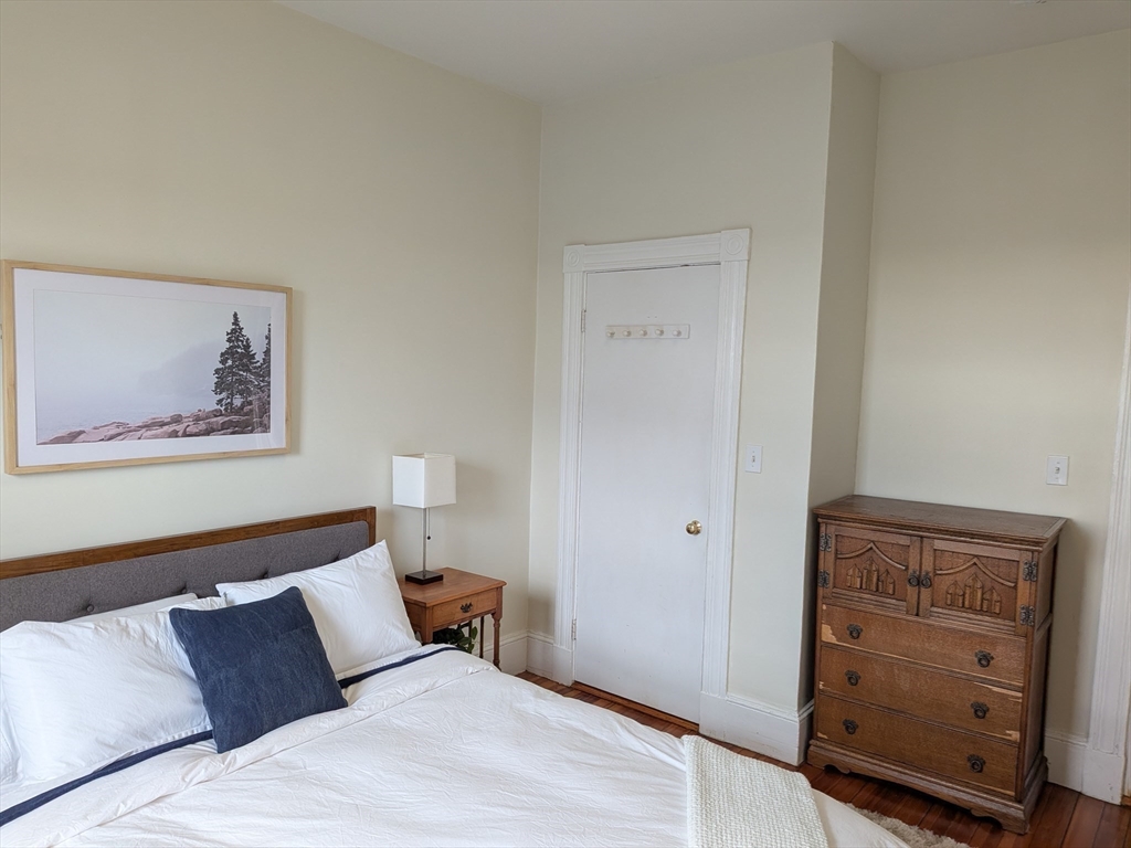 82 Gladstone Street, Unit 2 Boston, MA 02128 - Photo 15 of 23 a bedroom with a bed and a window