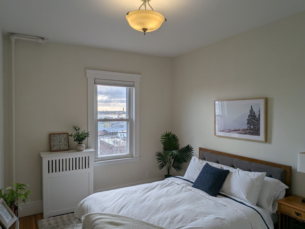 82 Gladstone Street, Unit 2 Boston, MA 02128 - Photo 16 of 23 a bedroom with a bed and a window