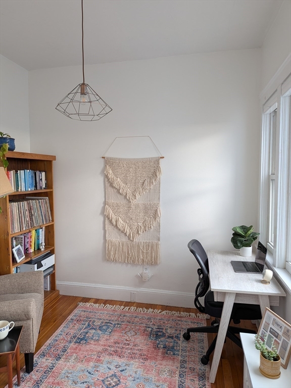 82 Gladstone Street, Unit 2 Boston, MA 02128 - Photo 18 of 23 a view of a workspace with furniture and a book shelf