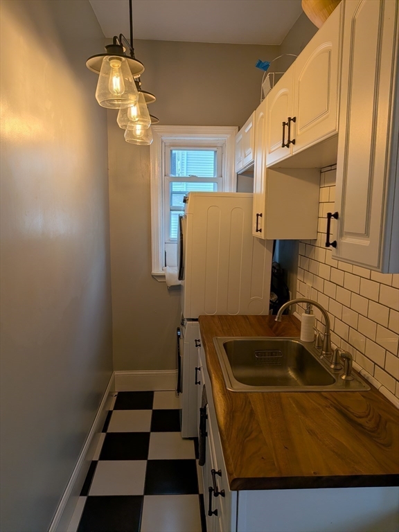 82 Gladstone Street, Unit 2 Boston, MA 02128 - Photo 20 of 23 a bathroom with a sink and a mirror