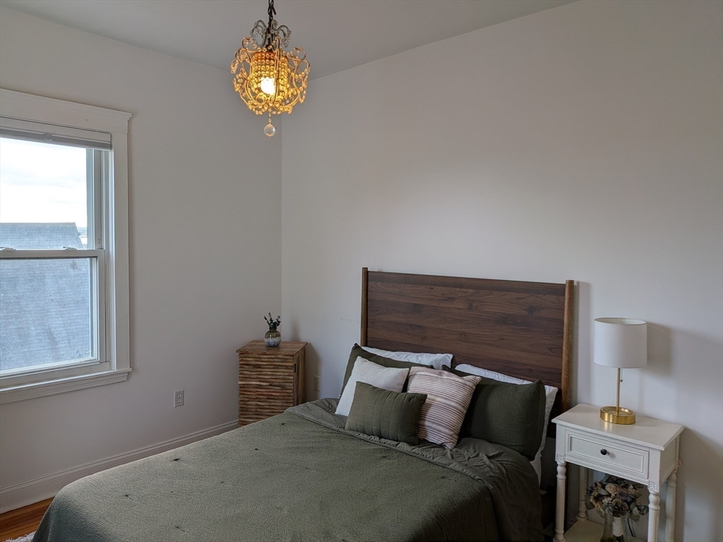 82 Gladstone Street, Unit 2 Boston, MA 02128 - Photo 21 of 23 a bedroom with a bed and a window