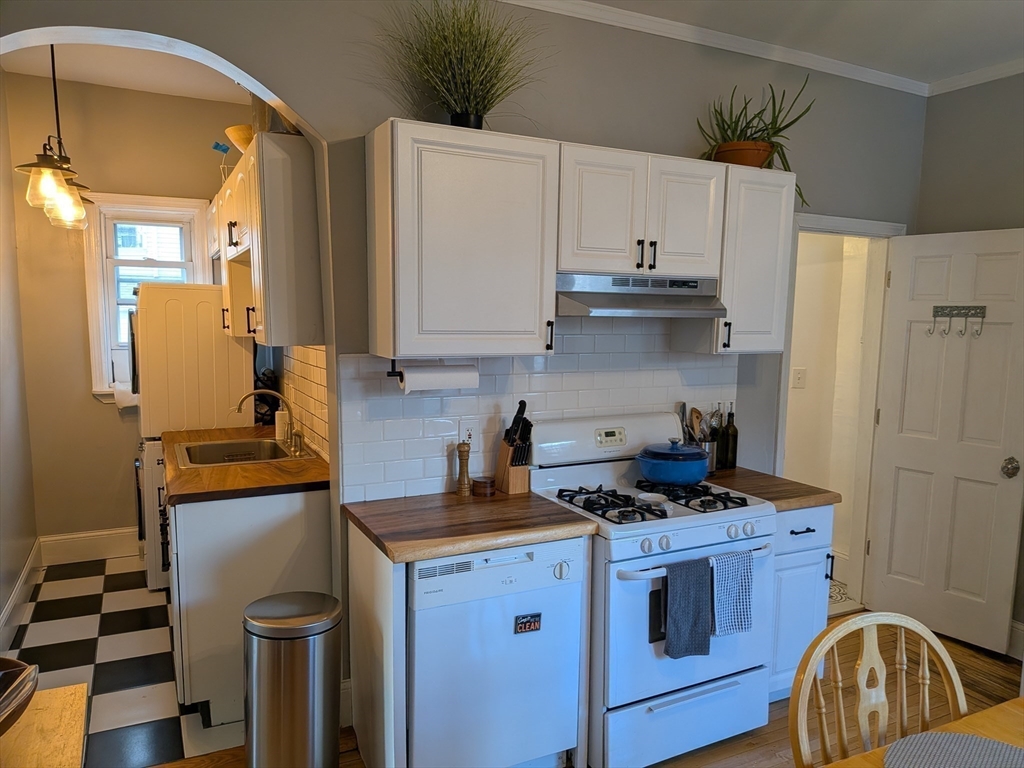 82 Gladstone Street, Unit 2 Boston, MA 02128 - Photo 6 of 23 a kitchen with a stove and a refrigerator