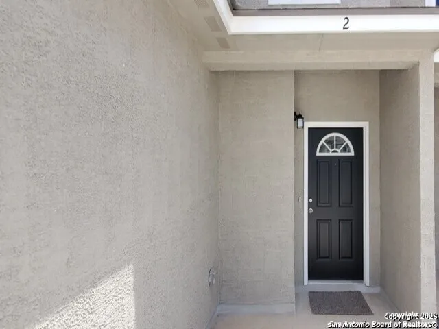 a view of front door with wooden floor