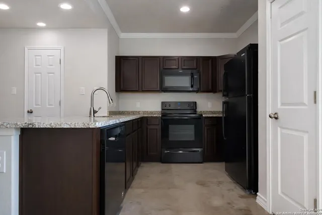 a kitchen with granite countertop stainless steel appliances and a counter space