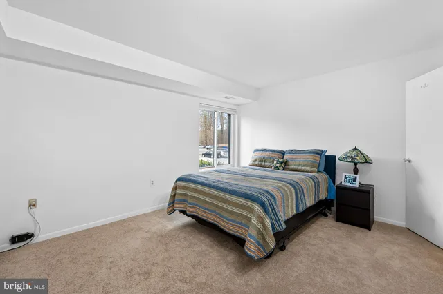 a spacious bedroom with a bed and a cabinets