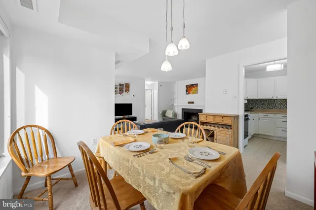 a view of a dining room with furniture and a chandelier