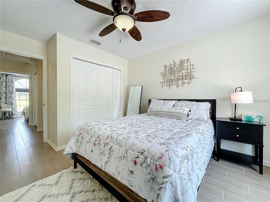 17528 East Apshawa Road Minneola, FL 34715 - Photo 14 of 22 a bedroom with bed and wooden floor