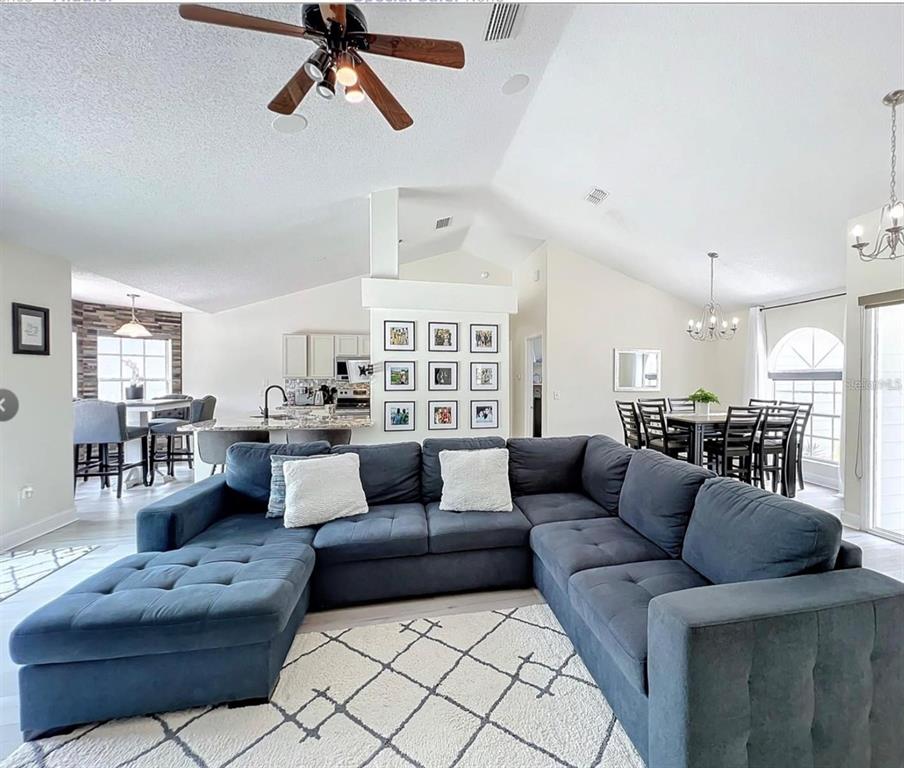 17528 East Apshawa Road Minneola, FL 34715 - Photo 3 of 22 a living room with furniture and a view of kitchen