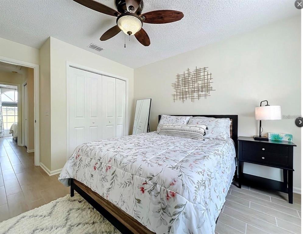 17528 East Apshawa Road Minneola, FL 34715 - Photo 5 of 22 a bedroom with bed and wooden floor