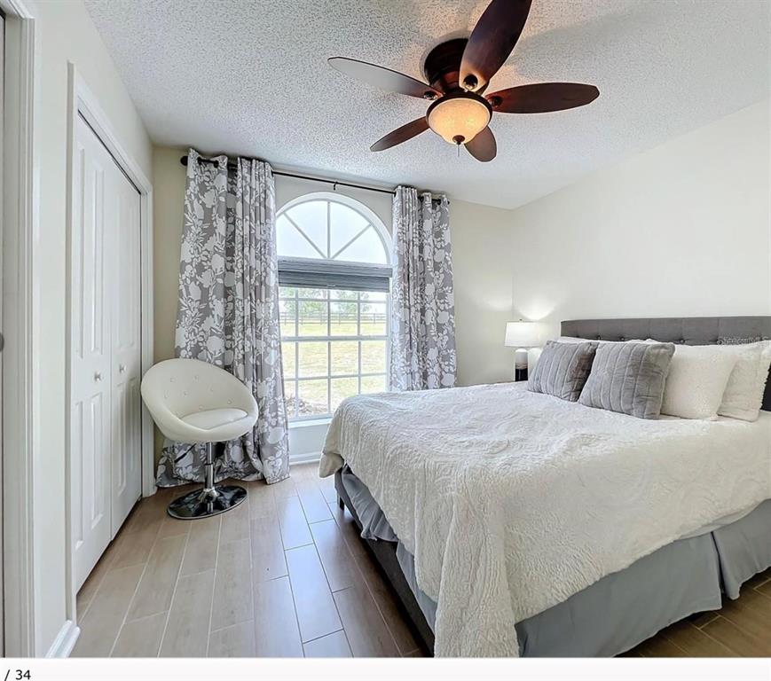 17528 East Apshawa Road Minneola, FL 34715 - Photo 8 of 22 a bedroom with a bed and a table