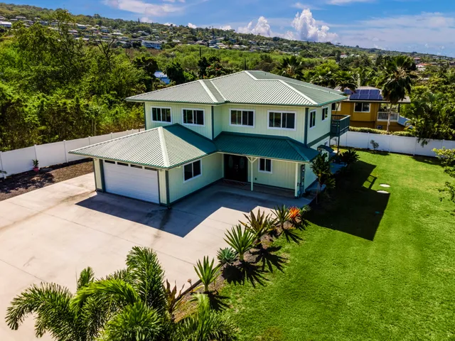 an aerial view of a house with a garden and a yard