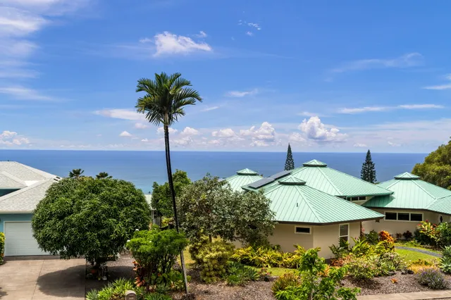 a view of a white house with a yard