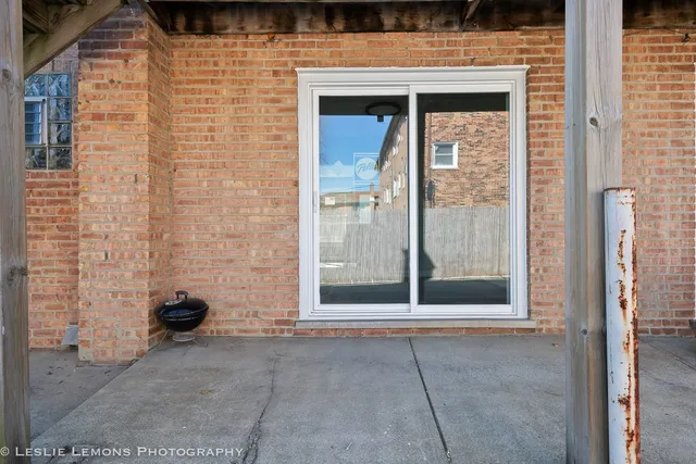 a view of a brick house with an outdoor space