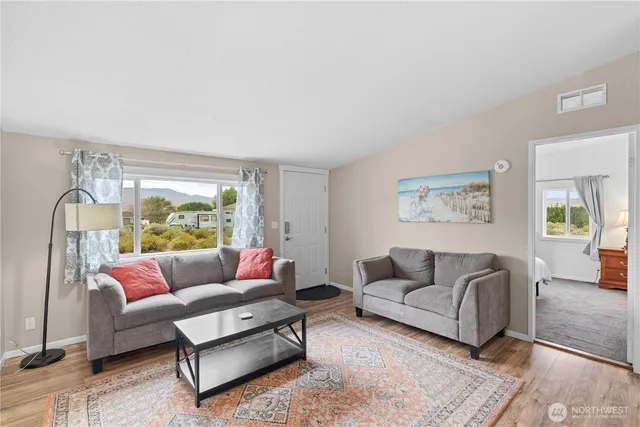 a living room with furniture and a large window