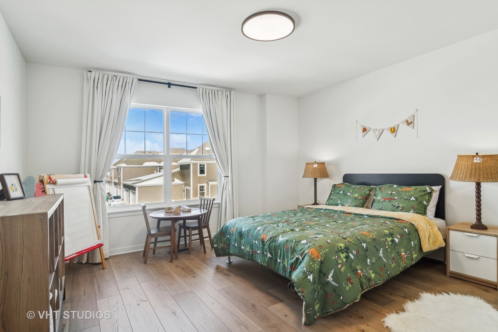 253 Hoffman Drive Buffalo Grove, IL 60089 - Photo 16 of 32 a bedroom with a bed and a table in it