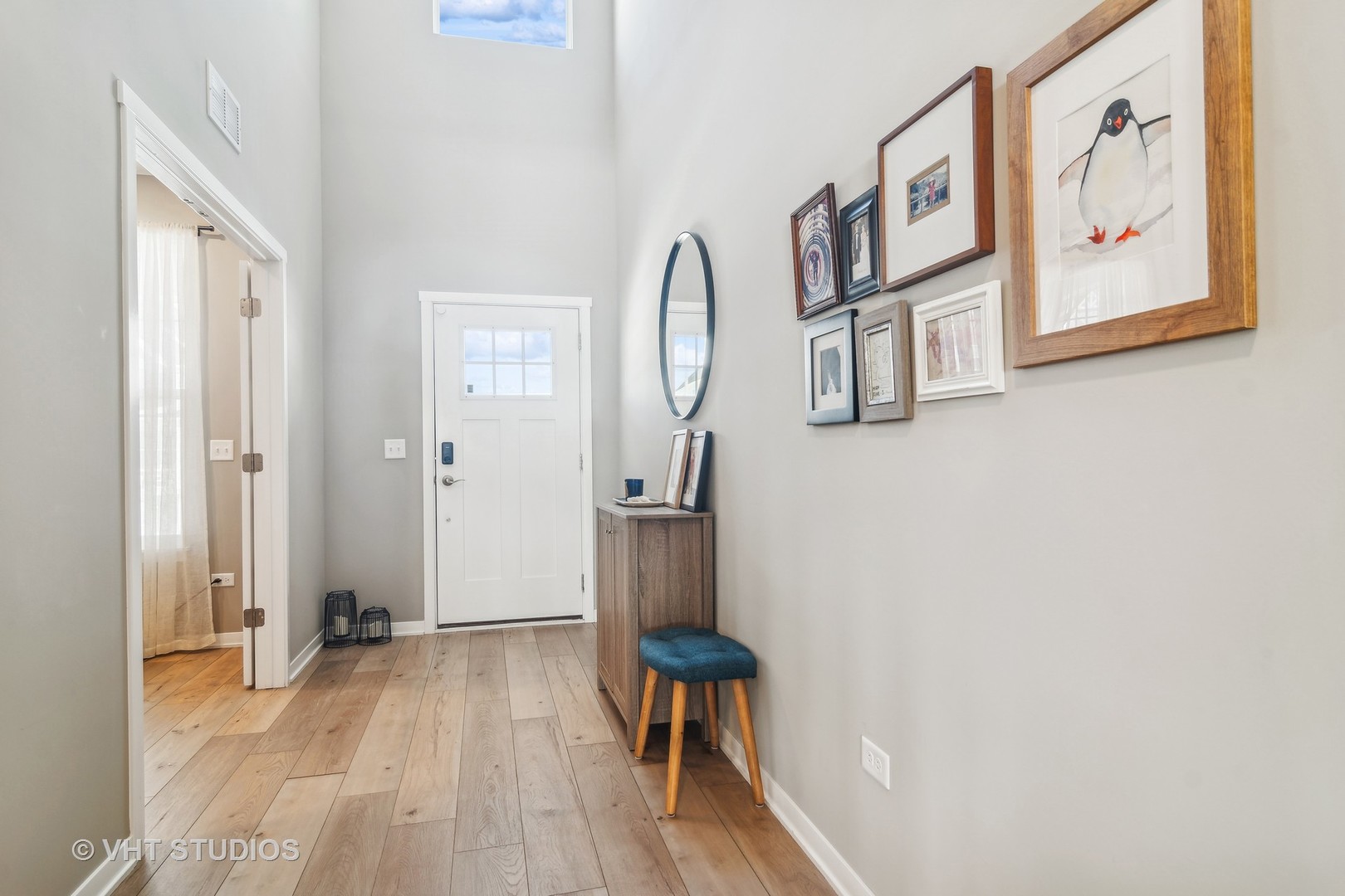 253 Hoffman Drive Buffalo Grove, IL 60089 - Photo 2 of 32 a view of a hallway with paintings on the wall