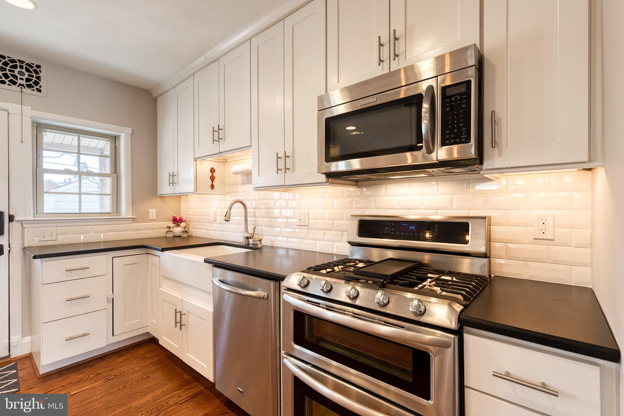 45 Dunkirk Road Baltimore, MD 21212 - Photo 24 of 45 a kitchen with cabinets stainless steel appliances and wooden floor