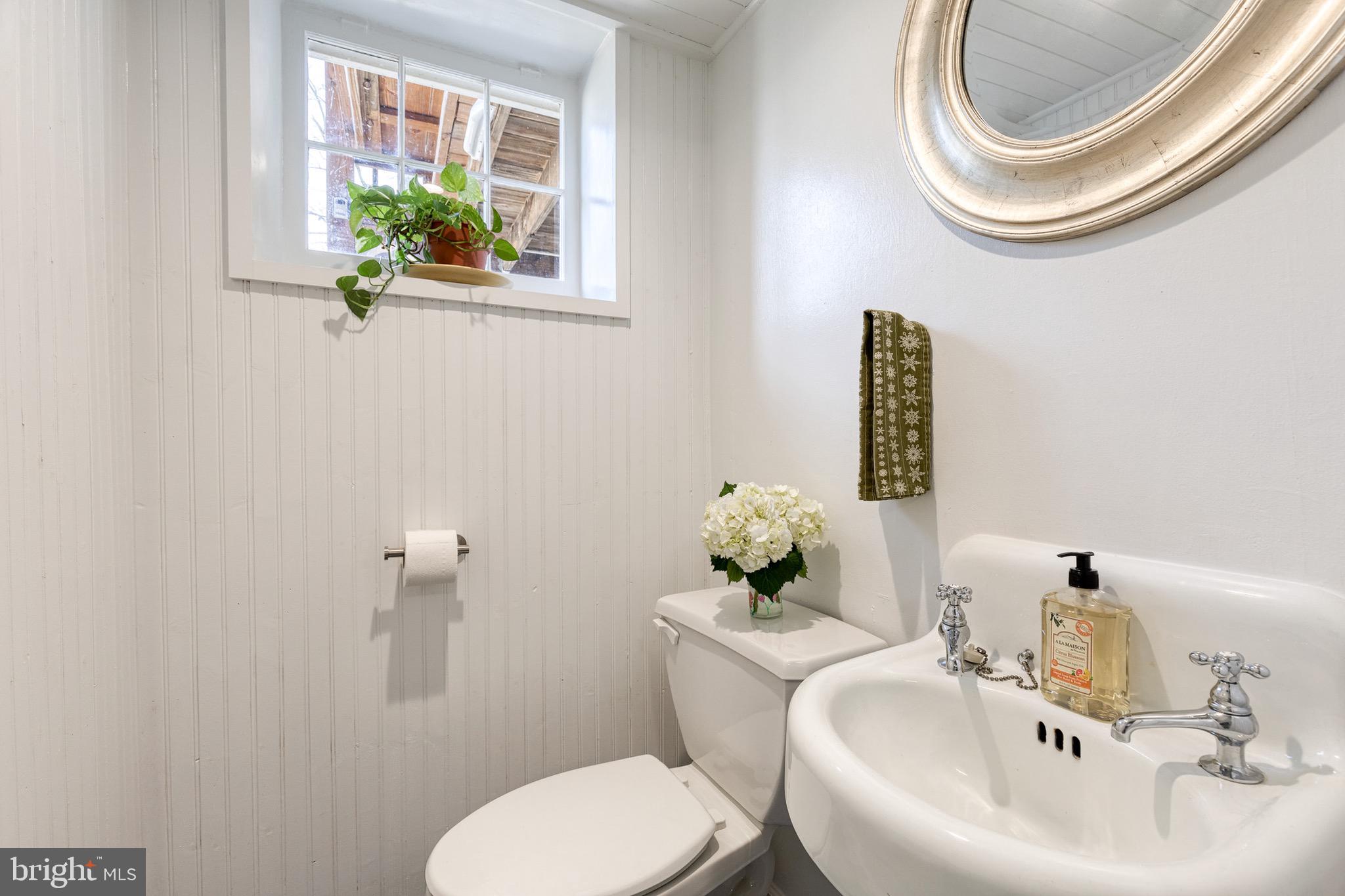 45 Dunkirk Road Baltimore, MD 21212 - Photo 37 of 45 a bathroom with a sink mirror and toilet