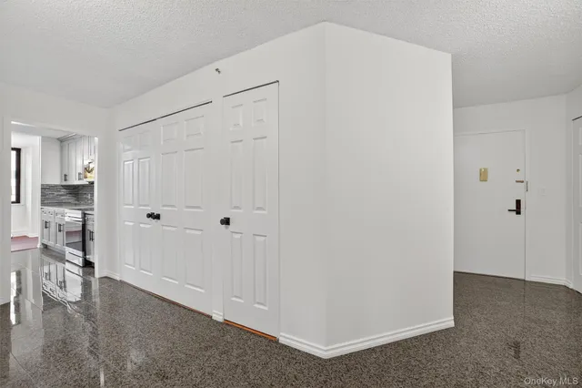a view of a kitchen with refrigerator and wooden floor