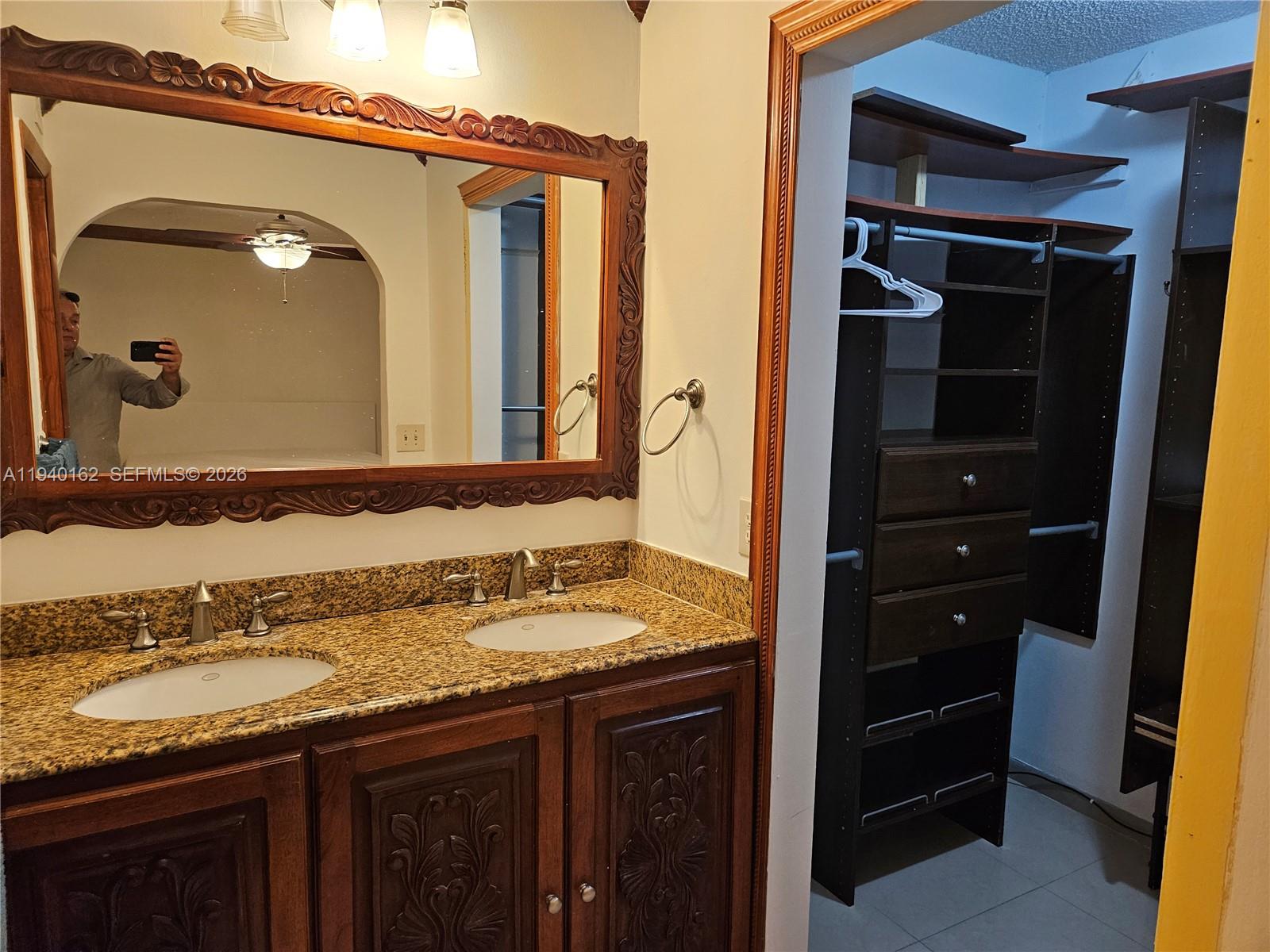 9154 Southwest 132nd Lane, Unit 1 Miami, FL 33176 - Photo 11 of 14 a bathroom with a granite countertop sink and a mirror