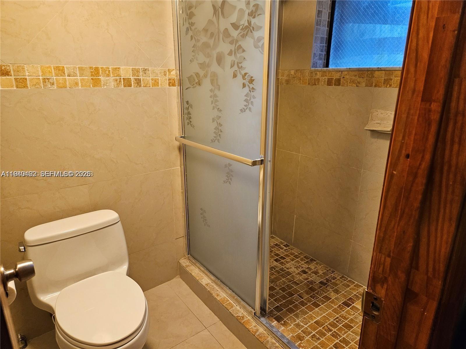 9154 Southwest 132nd Lane, Unit 1 Miami, FL 33176 - Photo 12 of 14 a white toilet sitting next to a shower