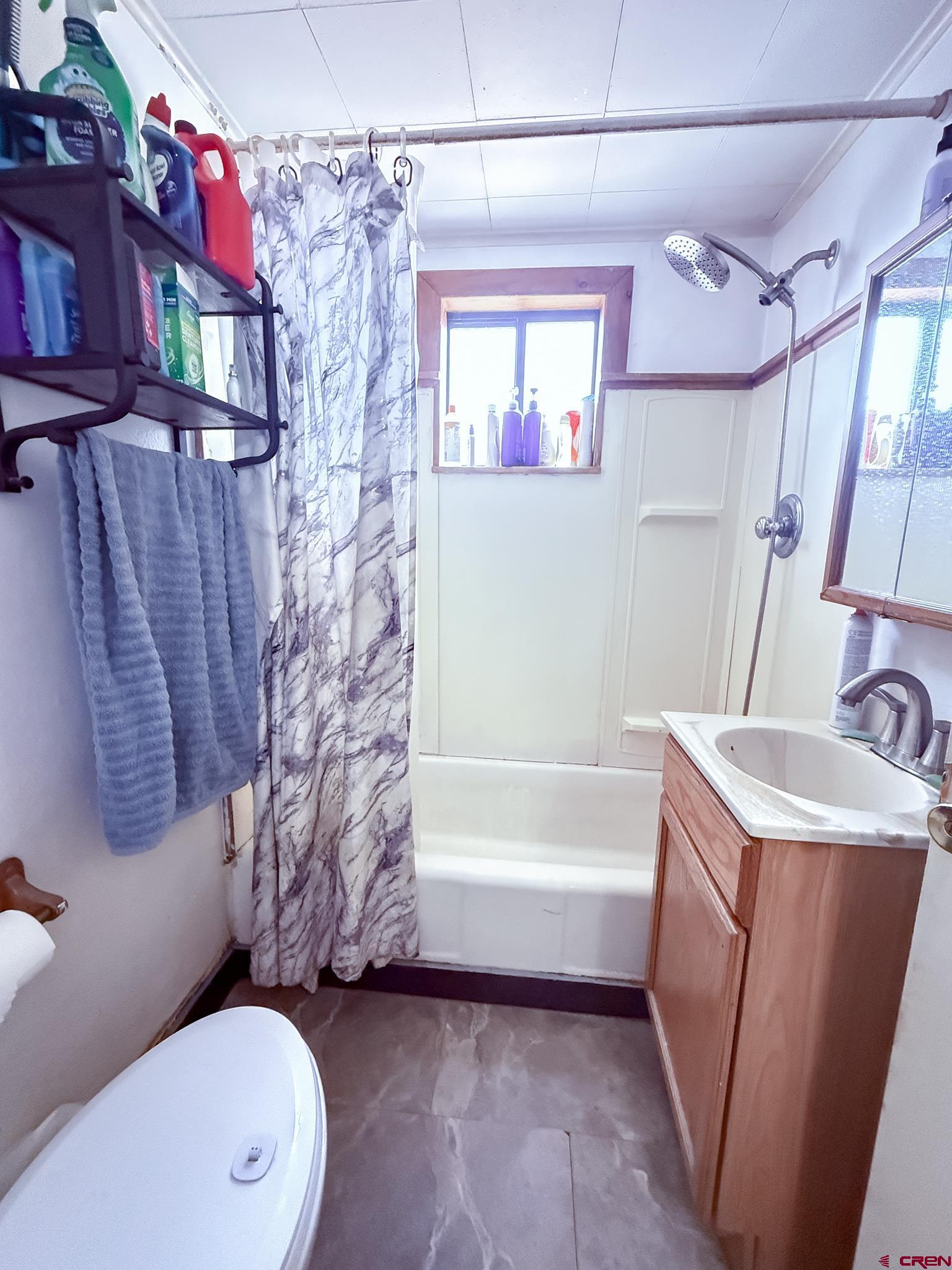 432 North Linden Street Cortez, CO 81321 - Photo 15 of 27 a bathroom with a sink a toilet a mirror a vanity and bathtub