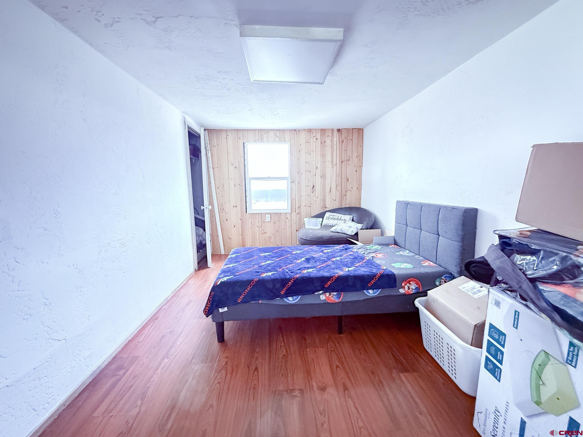 432 North Linden Street Cortez, CO 81321 - Photo 18 of 27 a bedroom with a bed and wooden floor