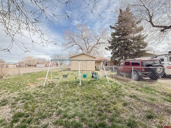 a view of a backyard of the house