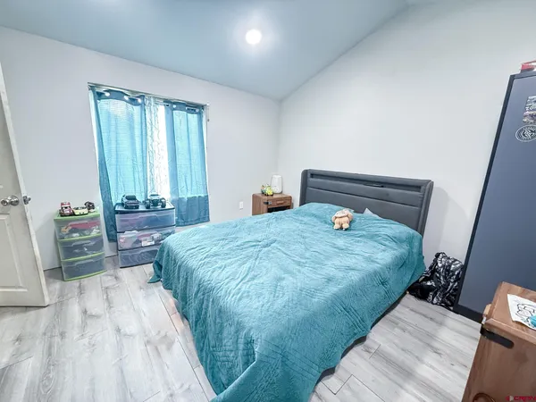 a bedroom with a bed and a mirror