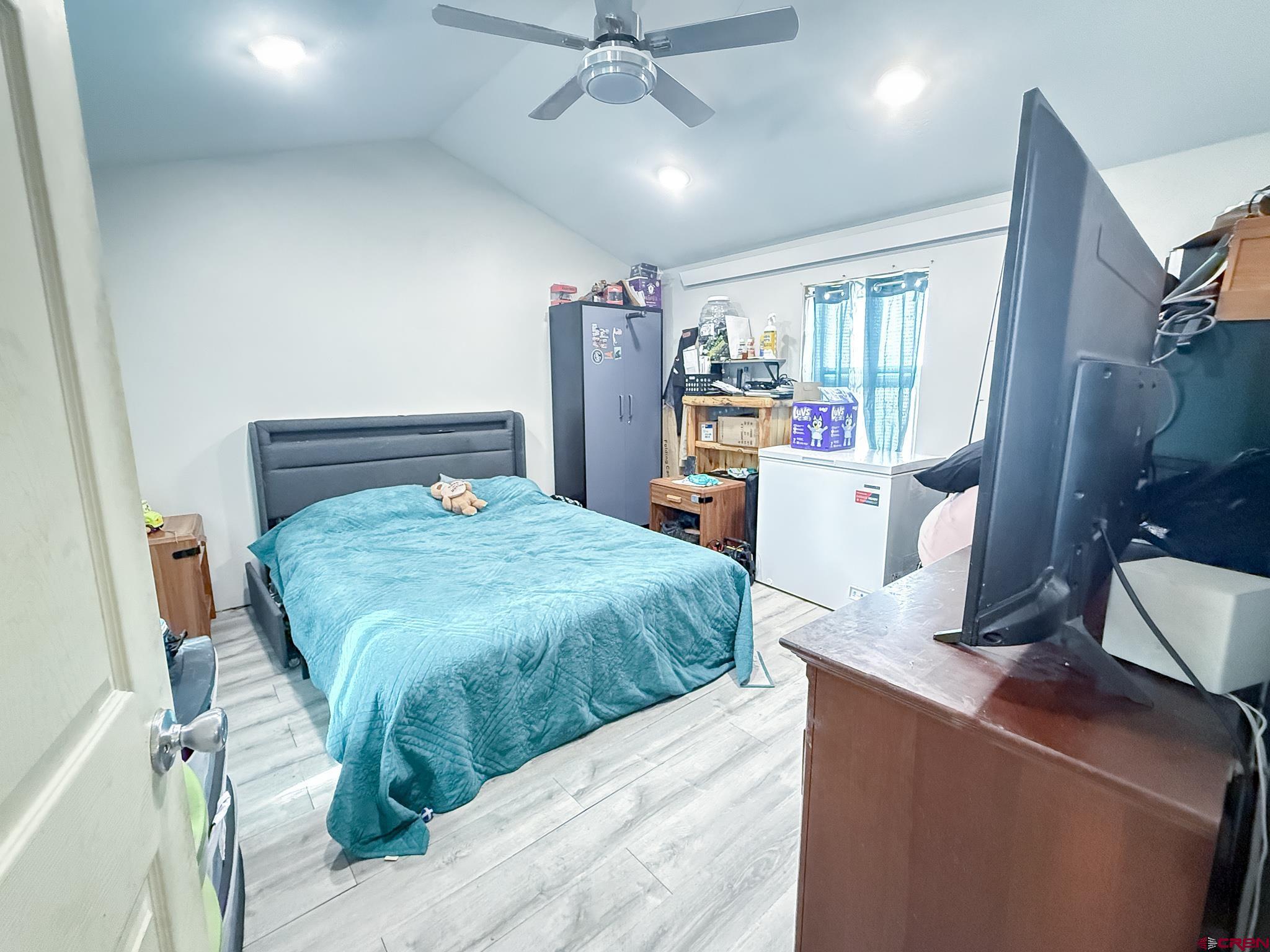432 North Linden Street Cortez, CO 81321 - Photo 6 of 27 a bedroom with a bed and a chandelier