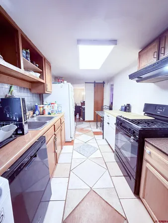 a kitchen with stainless steel appliances granite countertop a sink and cabinets