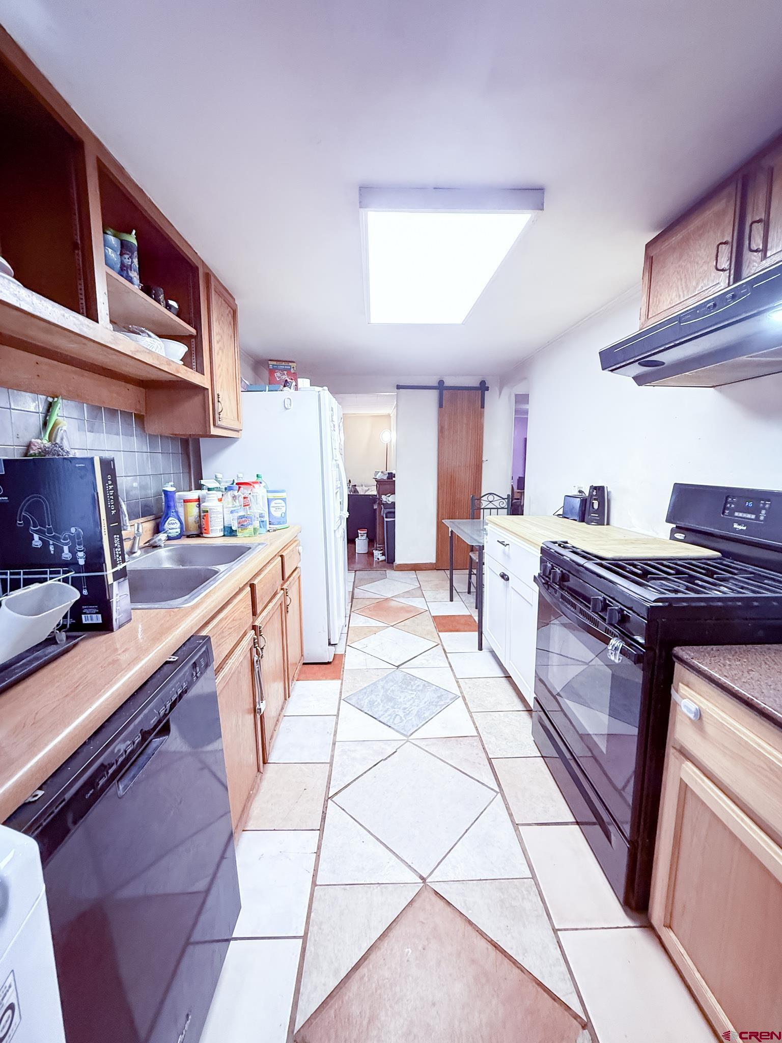 432 North Linden Street Cortez, CO 81321 - Photo 8 of 27 a kitchen with stainless steel appliances granite countertop a sink and cabinets