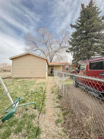a backyard of a house with table and chairs