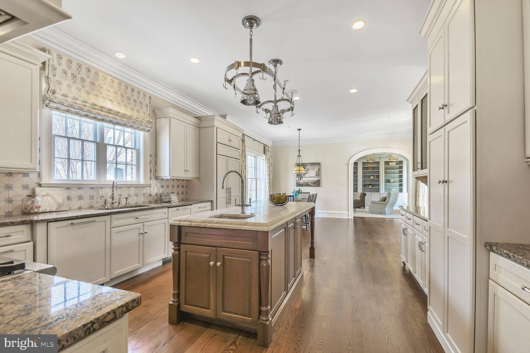 1935 Foxview Circle Northwest Washington, DC 20007 - Photo 15 of 52 a kitchen with stainless steel appliances granite countertop cabinets a stove a sink a dining table and chairs