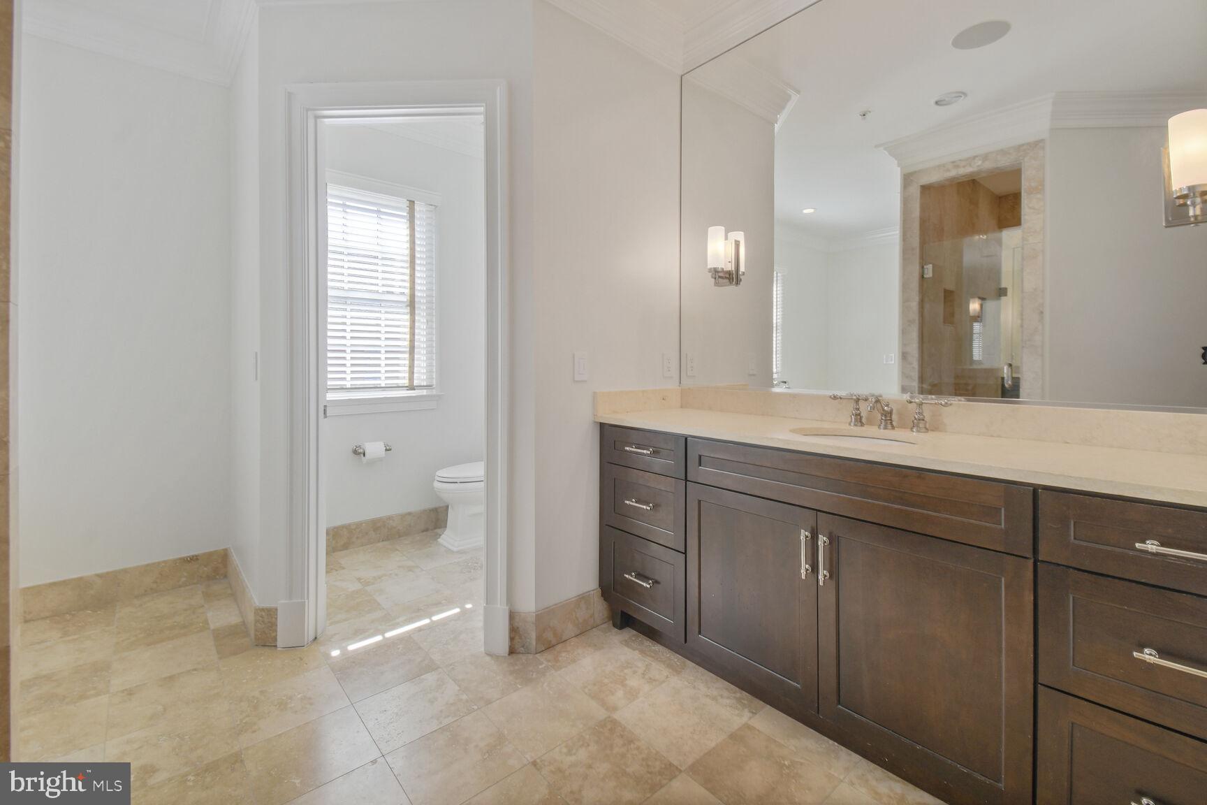 1935 Foxview Circle Northwest Washington, DC 20007 - Photo 24 of 52 a spacious bathroom with a granite countertop sink a mirror and a