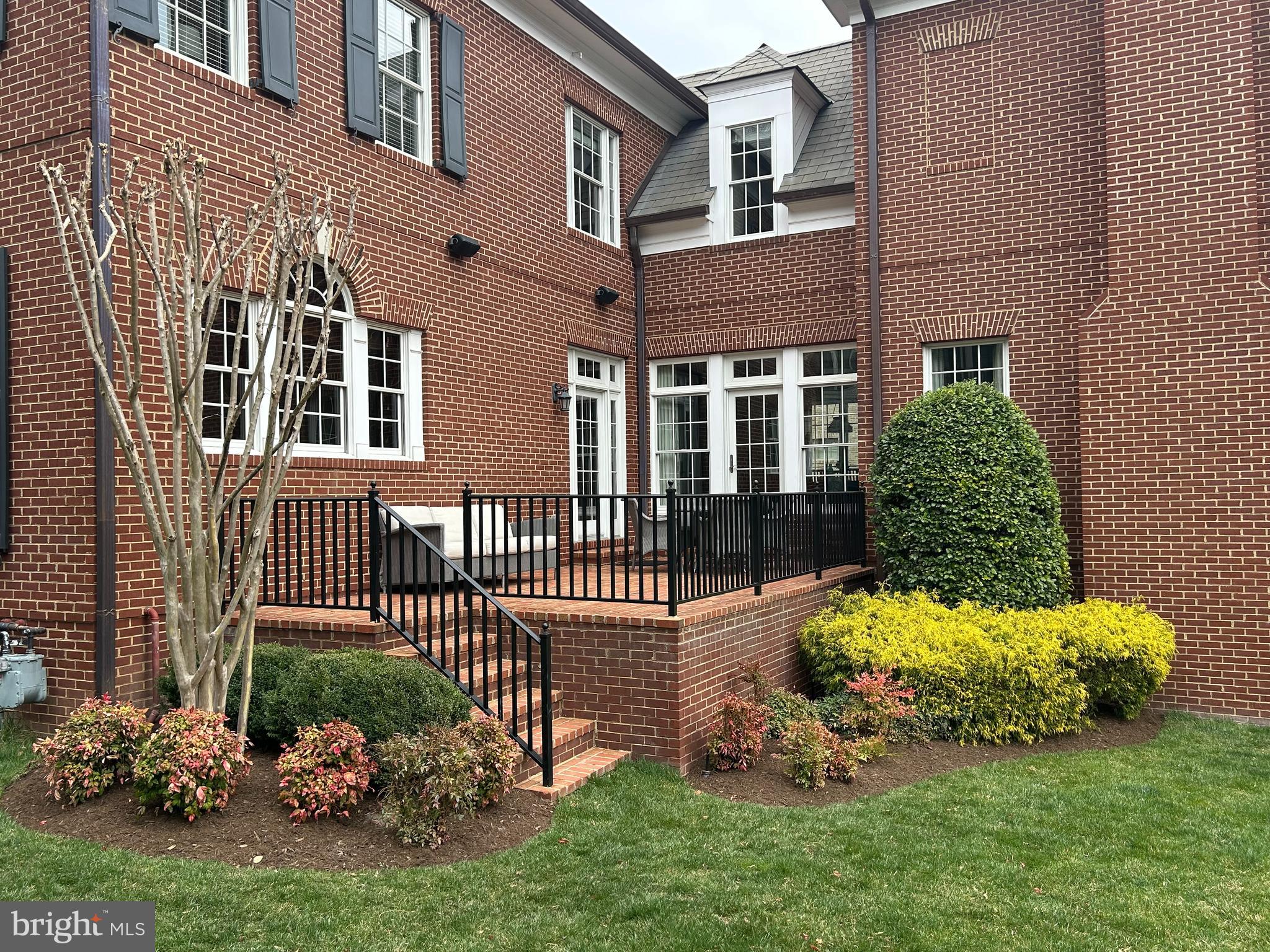 1935 Foxview Circle Northwest Washington, DC 20007 - Photo 3 of 52 a front view of a house with a yard and outdoor seating