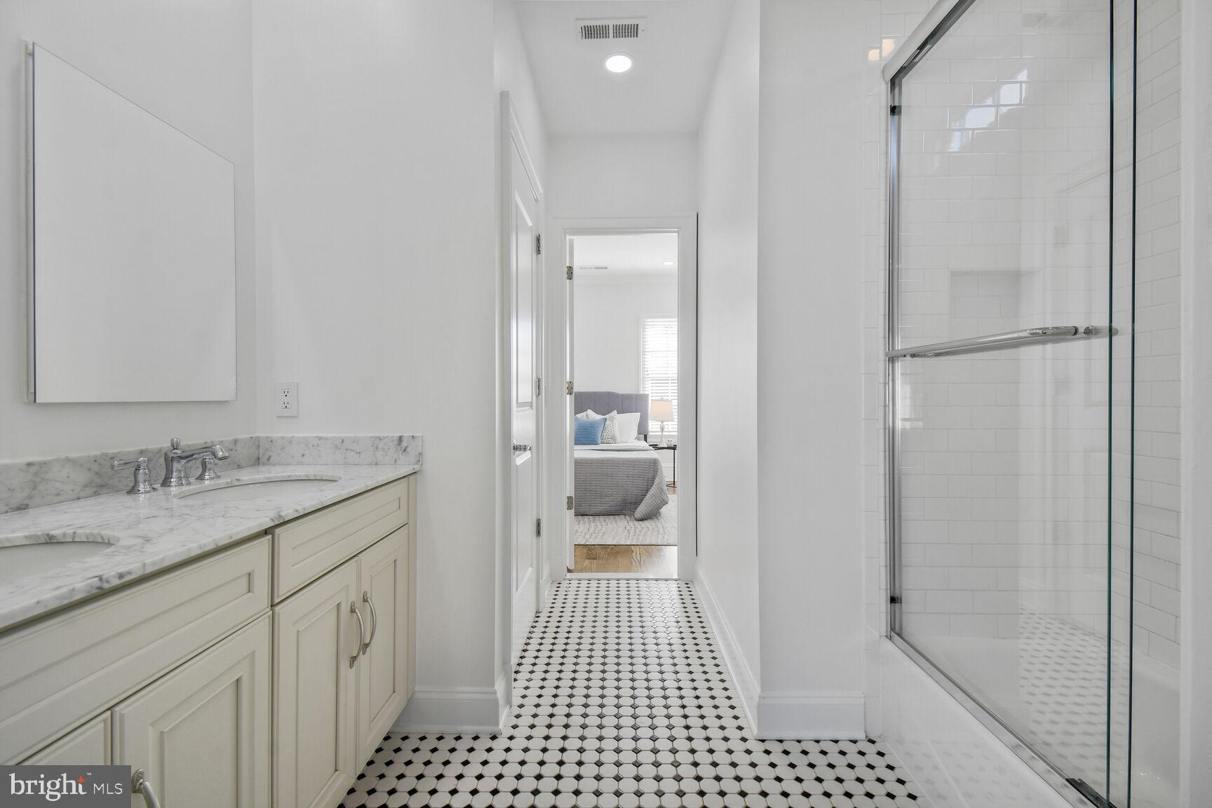1935 Foxview Circle Northwest Washington, DC 20007 - Photo 33 of 52 a bathroom with a granite countertop sink a toilet and a shower